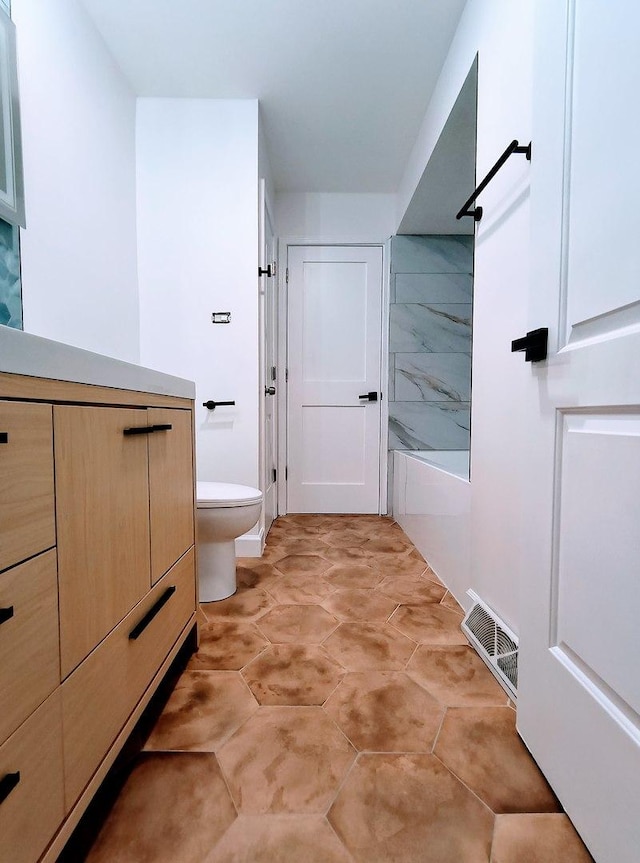 bathroom featuring toilet and walk in shower