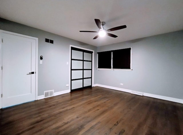 unfurnished bedroom featuring dark hardwood / wood-style floors and ceiling fan