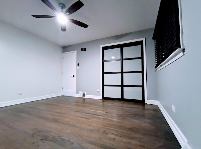 spare room with ceiling fan and dark hardwood / wood-style floors