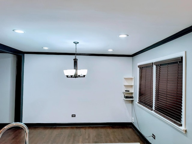 unfurnished dining area with dark hardwood / wood-style floors and crown molding