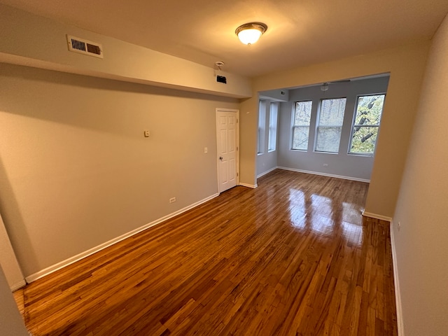 spare room featuring wood-type flooring