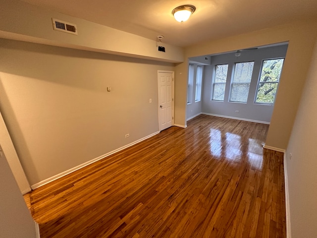 unfurnished room with hardwood / wood-style floors