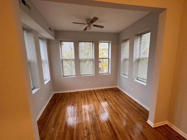 empty room with wood-type flooring and ceiling fan