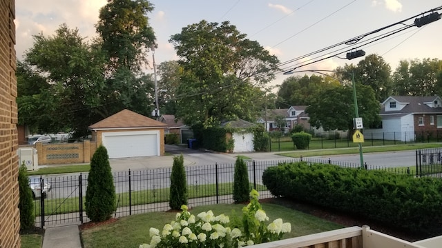 yard at dusk featuring an outbuilding and a garage