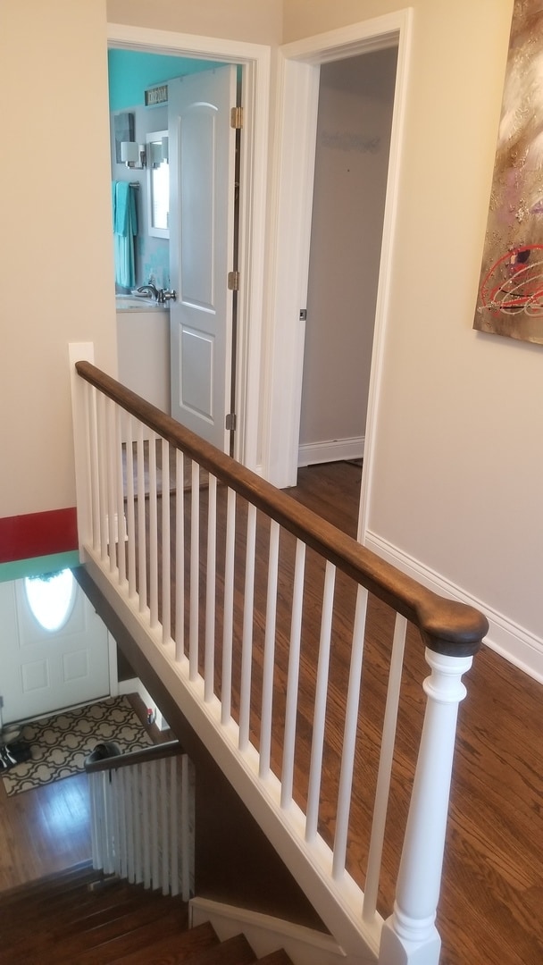 staircase with hardwood / wood-style floors