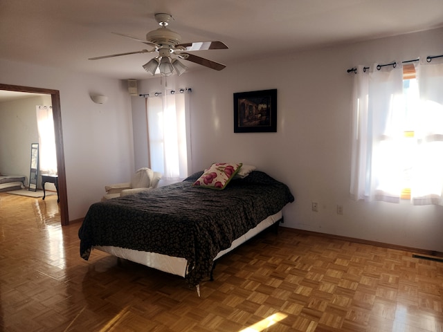 bedroom with ceiling fan and light parquet floors