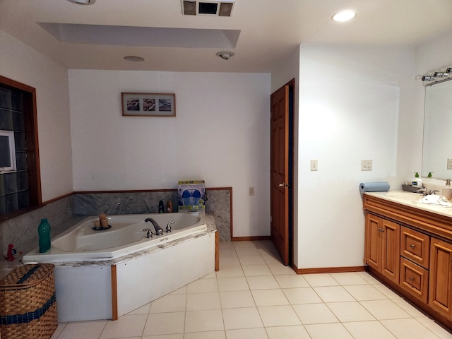 bathroom with vanity, tile patterned floors, and a tub