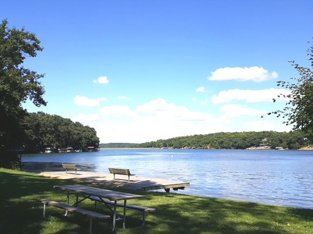 exterior space featuring a water view and a lawn