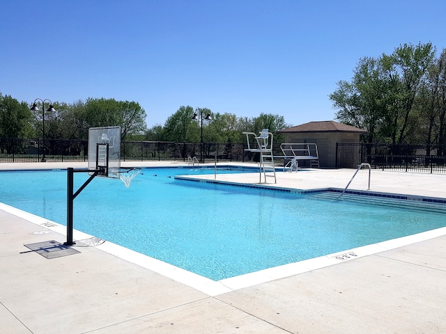 view of pool featuring basketball court