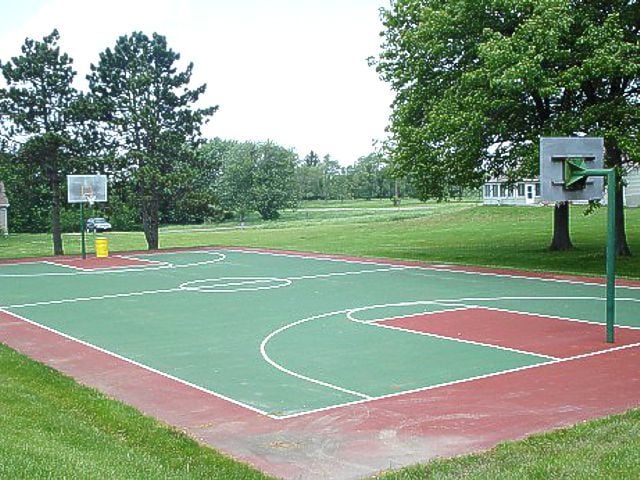 view of basketball court featuring a lawn