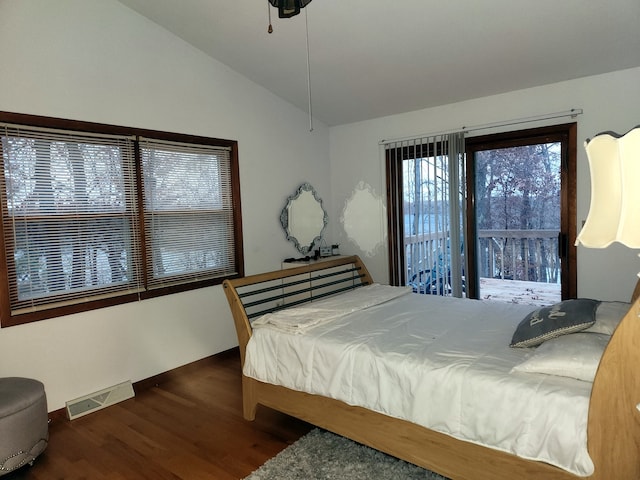 bedroom with access to outside, dark hardwood / wood-style floors, and vaulted ceiling