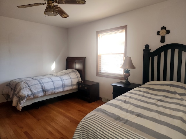 bedroom with ceiling fan and wood-type flooring