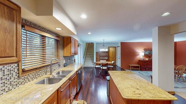 kitchen with pendant lighting, a center island, sink, decorative backsplash, and dark hardwood / wood-style flooring