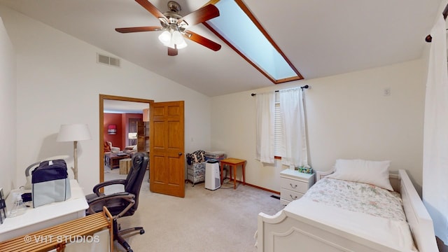 carpeted bedroom with lofted ceiling with skylight and ceiling fan