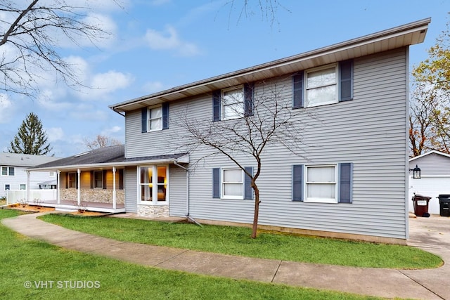 view of front of home featuring covered porch and a front yard