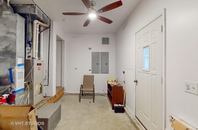 interior space featuring radiator, heating unit, electric panel, and ceiling fan