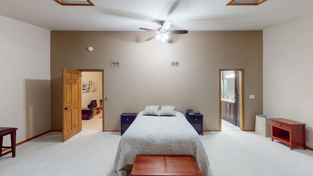 carpeted bedroom featuring connected bathroom and ceiling fan