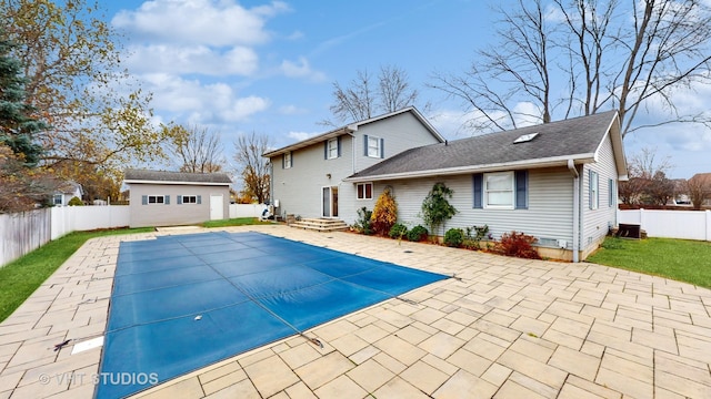 view of pool featuring a patio area and an outbuilding