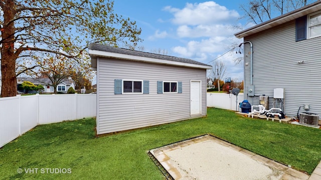 exterior space featuring an outdoor structure, a patio area, and central AC unit