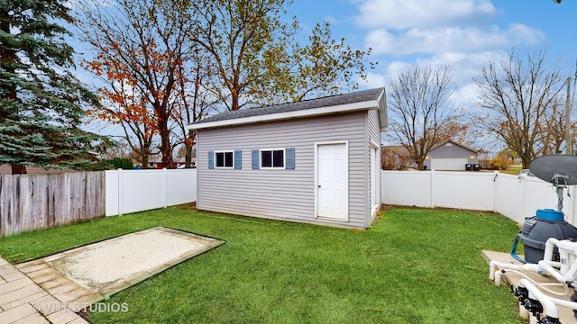 view of outdoor structure featuring a lawn