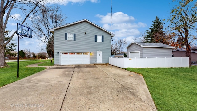 view of side of property with a lawn and a garage