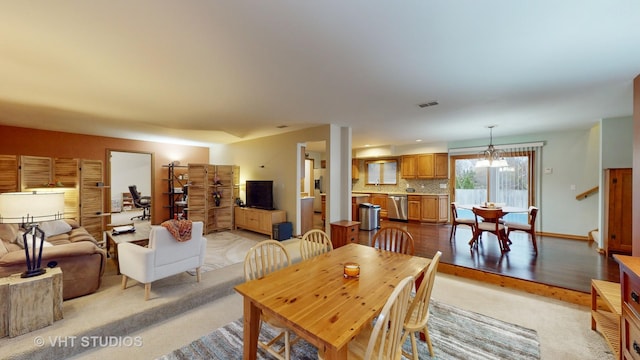 dining area with a notable chandelier and light hardwood / wood-style floors