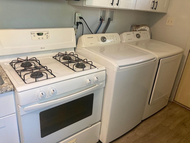 laundry room with dark hardwood / wood-style flooring and washing machine and dryer