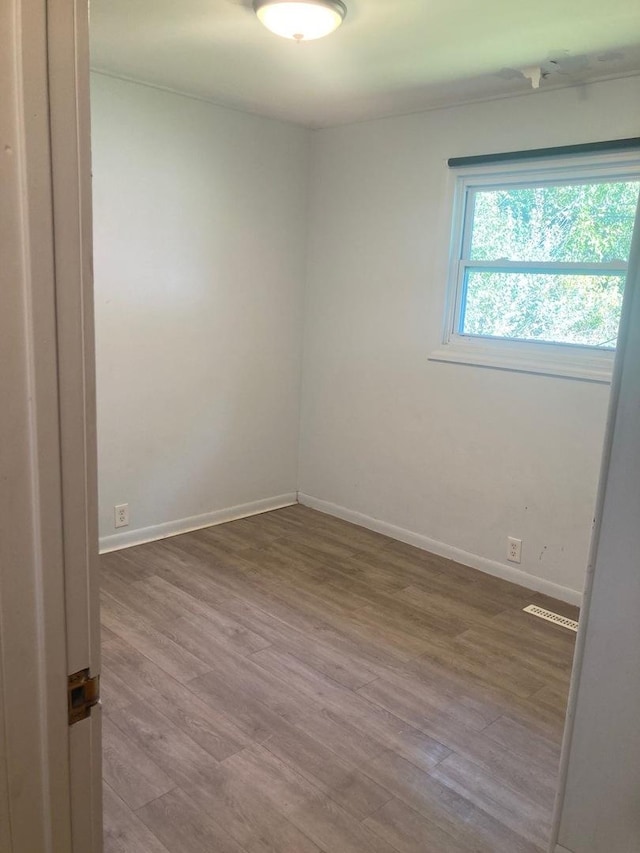 unfurnished room featuring hardwood / wood-style floors