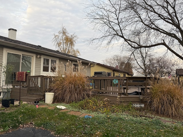 back of house with a deck