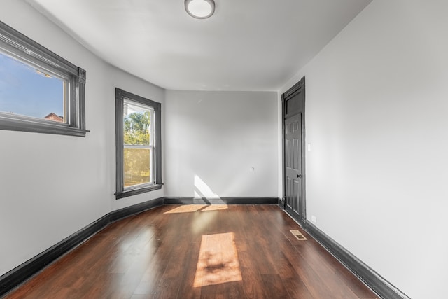 unfurnished room featuring dark hardwood / wood-style flooring