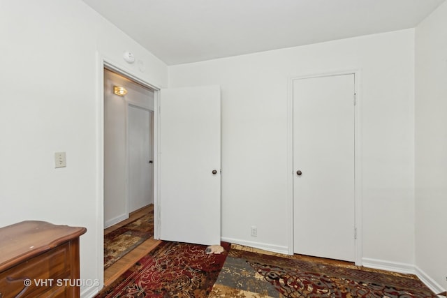 bedroom with dark hardwood / wood-style flooring