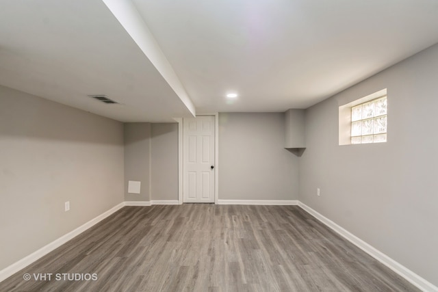 basement featuring hardwood / wood-style flooring