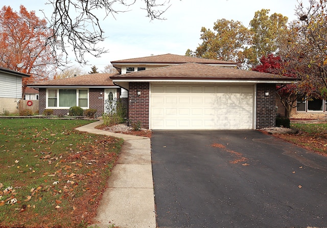 view of front of property with a front lawn and a garage