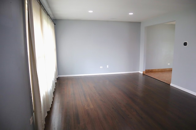 unfurnished room featuring dark wood-type flooring