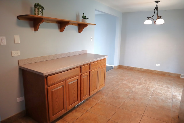 kitchen featuring light tile patterned floors, hanging light fixtures, and a notable chandelier