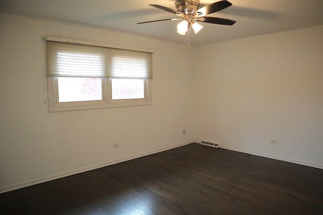 empty room with ceiling fan and dark wood-type flooring