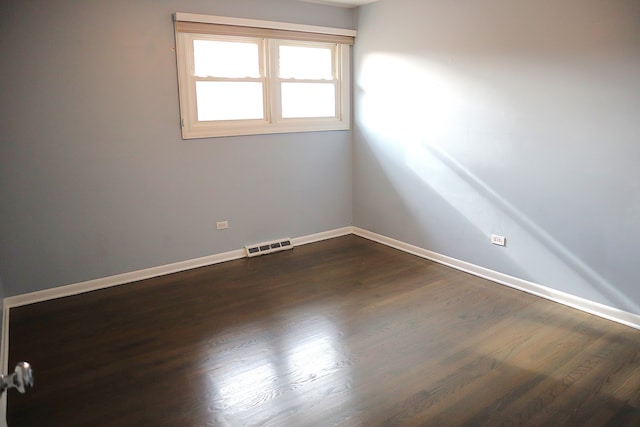 empty room with dark hardwood / wood-style floors