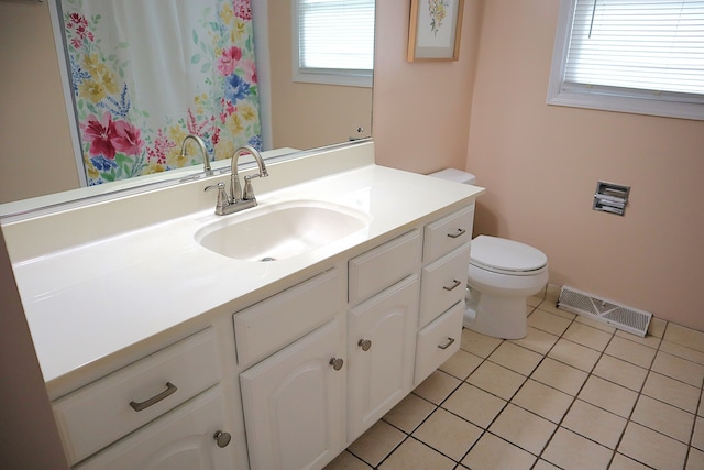 bathroom featuring tile patterned floors, vanity, and toilet