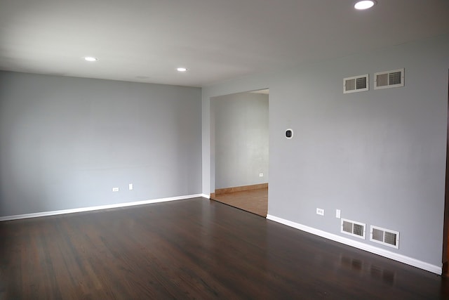 spare room featuring dark hardwood / wood-style flooring