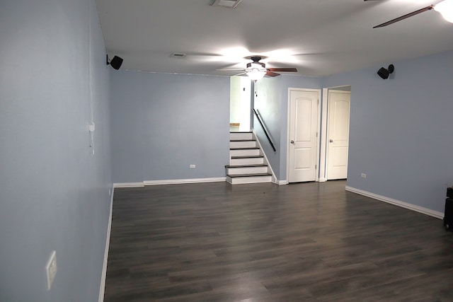 unfurnished room with ceiling fan and dark wood-type flooring