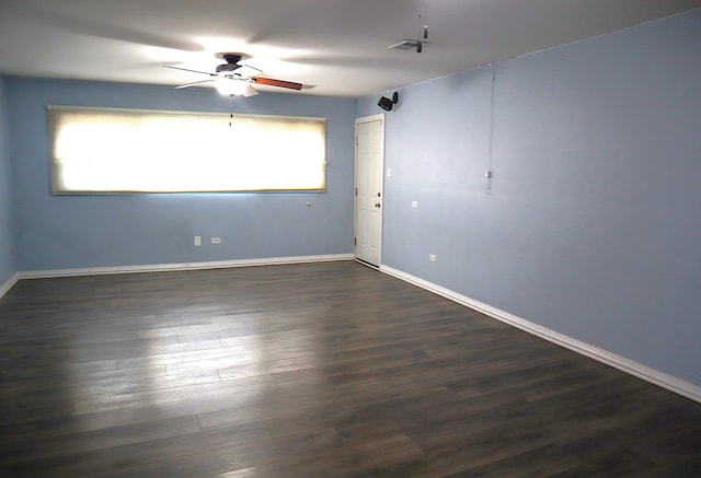 empty room featuring dark hardwood / wood-style floors and ceiling fan