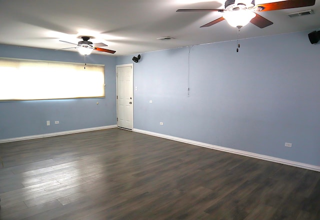 spare room featuring dark hardwood / wood-style floors and ceiling fan