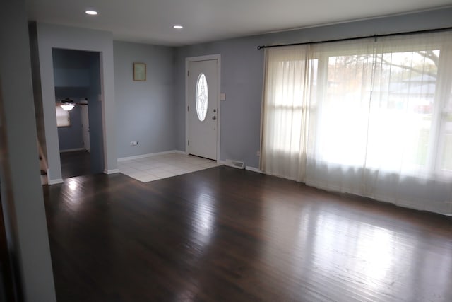 entryway with a wealth of natural light and light hardwood / wood-style flooring