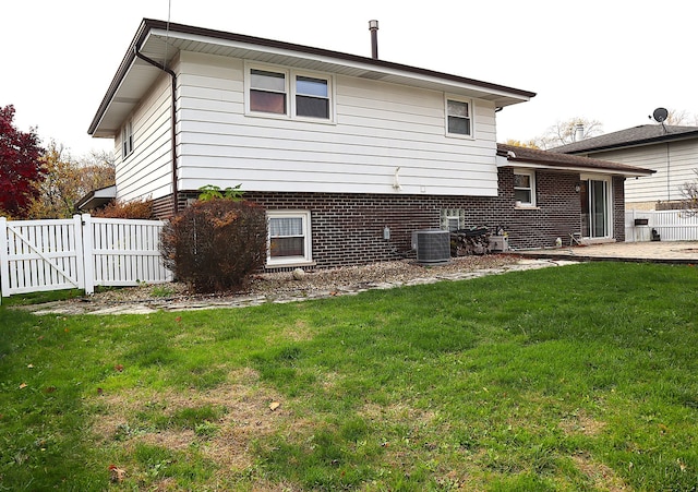 view of side of property featuring a lawn, cooling unit, and a patio