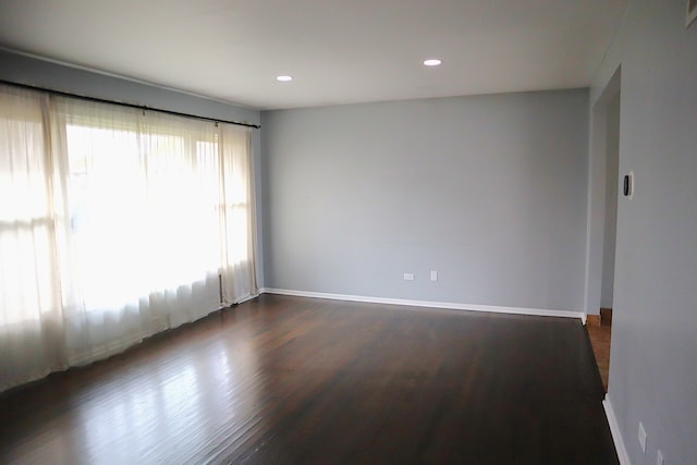 unfurnished room with dark hardwood / wood-style floors