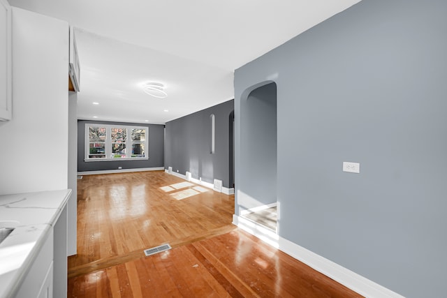 unfurnished living room with hardwood / wood-style flooring