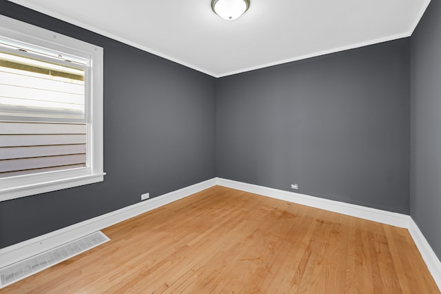 unfurnished room featuring hardwood / wood-style flooring and ornamental molding