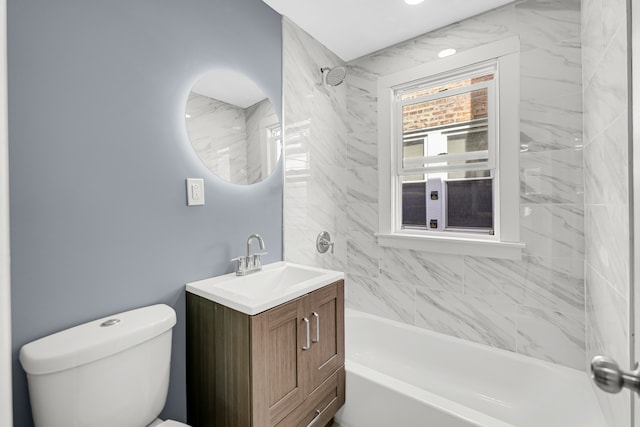 full bathroom featuring vanity, toilet, and tiled shower / bath