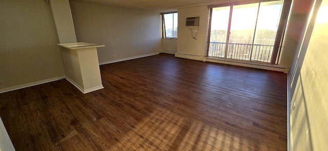 interior space featuring baseboards, baseboard heating, dark wood-type flooring, and a wall mounted AC