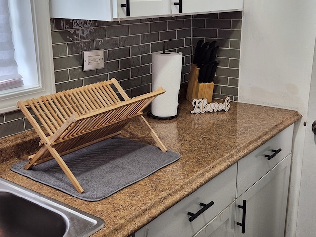 interior space with decorative backsplash and sink